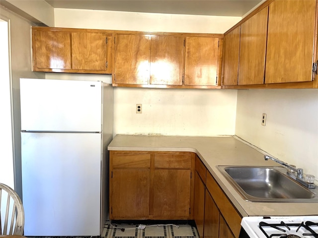 kitchen featuring sink and white appliances