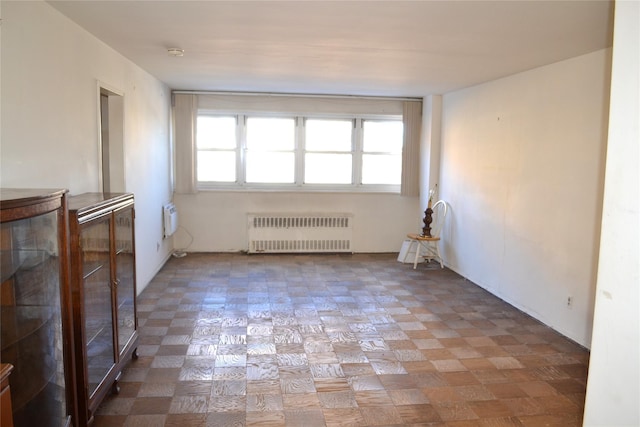 spare room featuring radiator heating unit