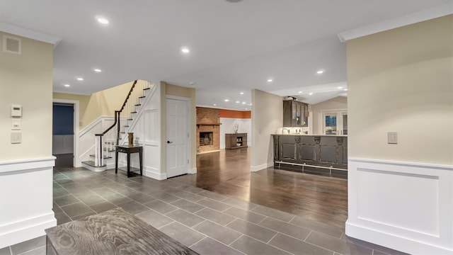 living room featuring a brick fireplace and dark tile patterned floors