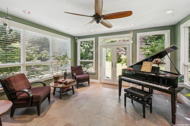 sitting room with ceiling fan, french doors, and a healthy amount of sunlight