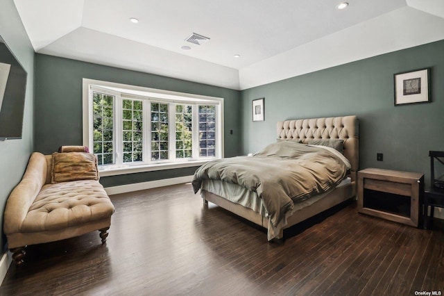 bedroom featuring hardwood / wood-style floors and a tray ceiling