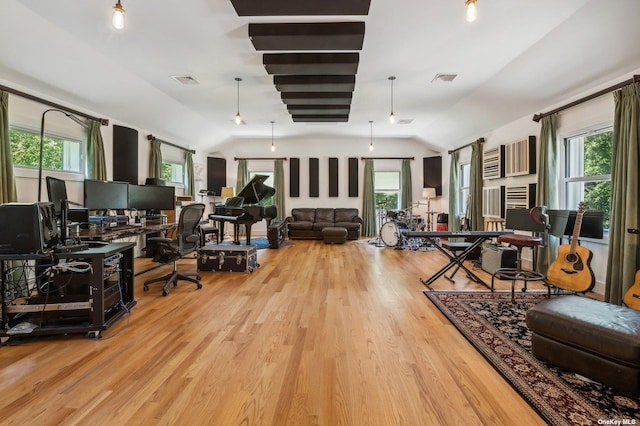 living room featuring vaulted ceiling and light hardwood / wood-style flooring