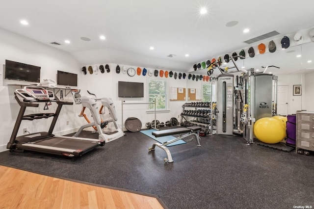 exercise room featuring vaulted ceiling