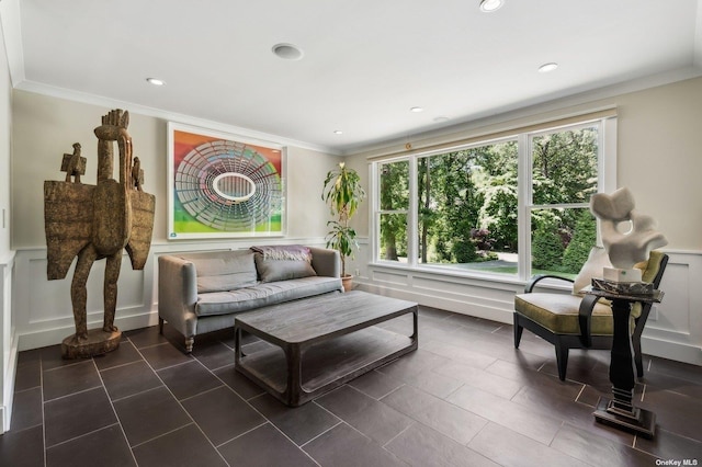 living room with ornamental molding, recessed lighting, a wainscoted wall, and a decorative wall