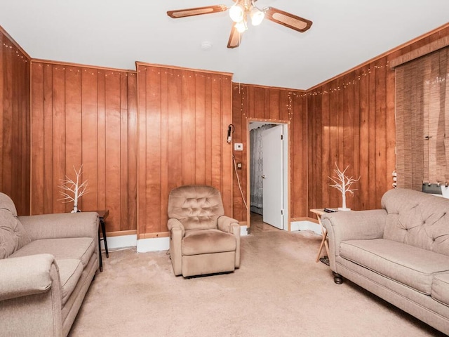 living room featuring ceiling fan, light colored carpet, and wooden walls