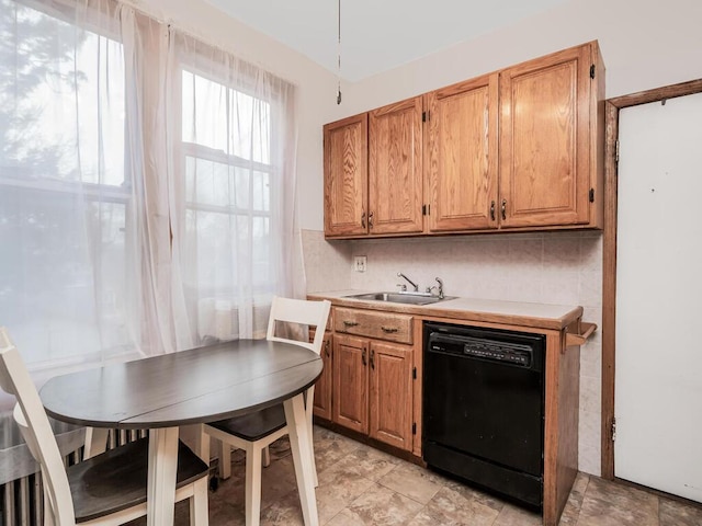 kitchen with black dishwasher, sink, and decorative backsplash