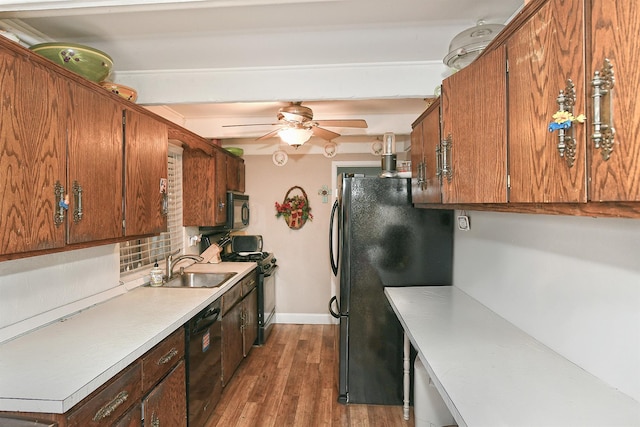 kitchen with ceiling fan, decorative backsplash, dark hardwood / wood-style flooring, black appliances, and sink