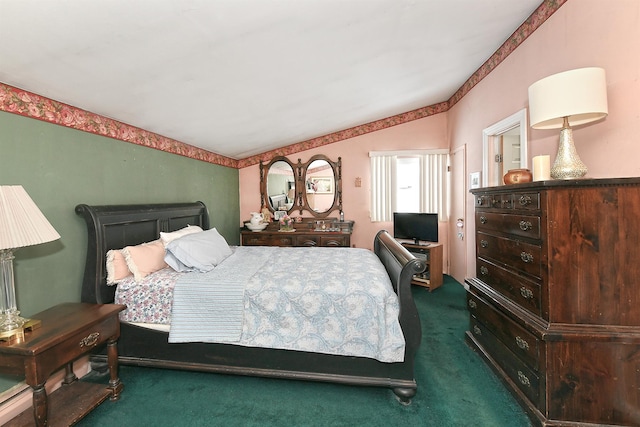 bedroom featuring vaulted ceiling and dark colored carpet