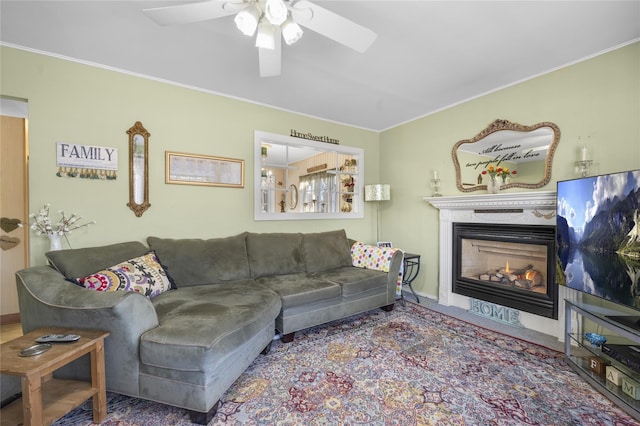 living room featuring a high end fireplace and ceiling fan