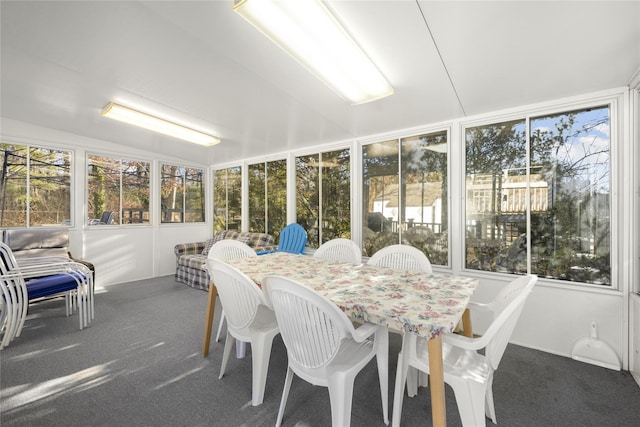 sunroom / solarium with vaulted ceiling and a healthy amount of sunlight