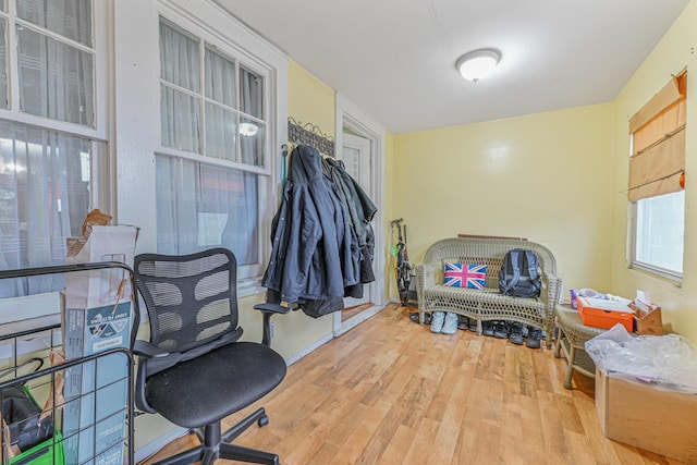 office with a healthy amount of sunlight and hardwood / wood-style flooring