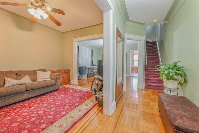 living room with ceiling fan and light parquet floors