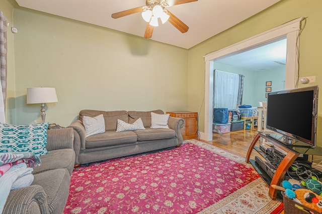 living room featuring ceiling fan and hardwood / wood-style floors