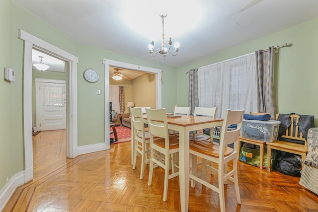 dining area featuring light parquet floors and a chandelier