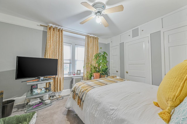 carpeted bedroom with ceiling fan and radiator