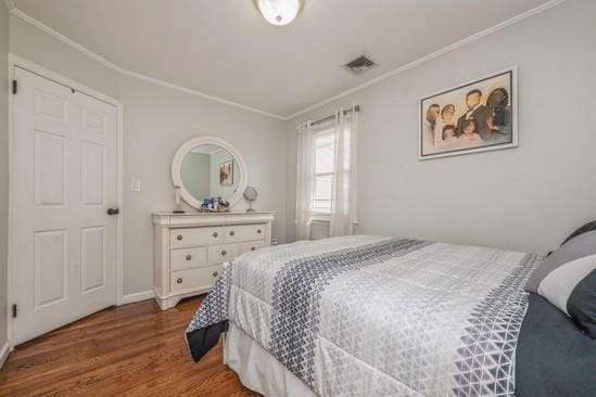 bedroom featuring hardwood / wood-style flooring and ornamental molding