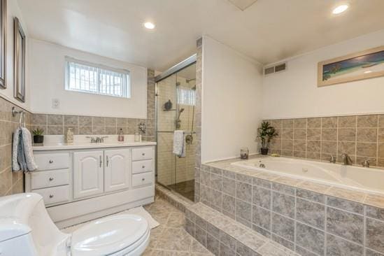 full bathroom featuring vanity, separate shower and tub, tile patterned floors, and toilet