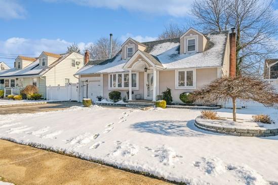 new england style home with a garage