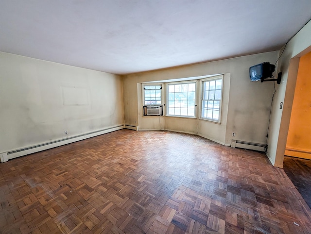 spare room featuring a baseboard radiator, cooling unit, and dark parquet flooring