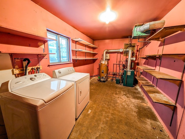 clothes washing area with gas water heater and independent washer and dryer