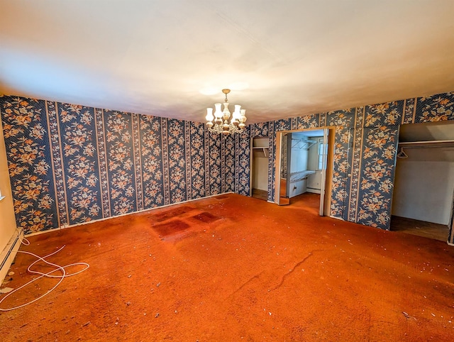 carpeted spare room featuring an inviting chandelier