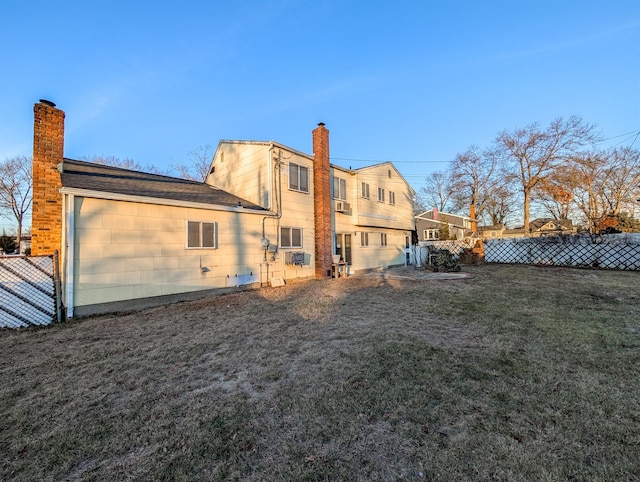 back of house with a lawn