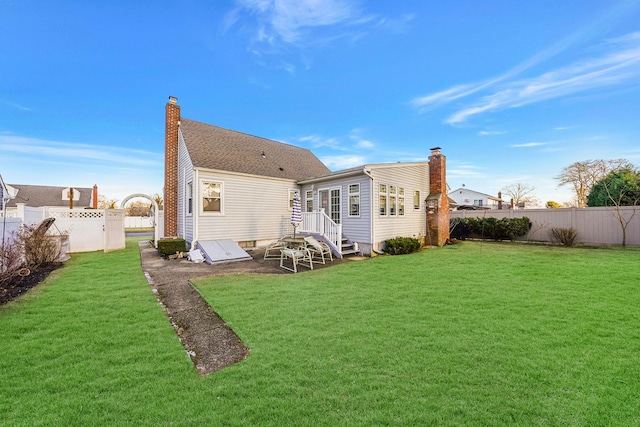 rear view of house with a yard