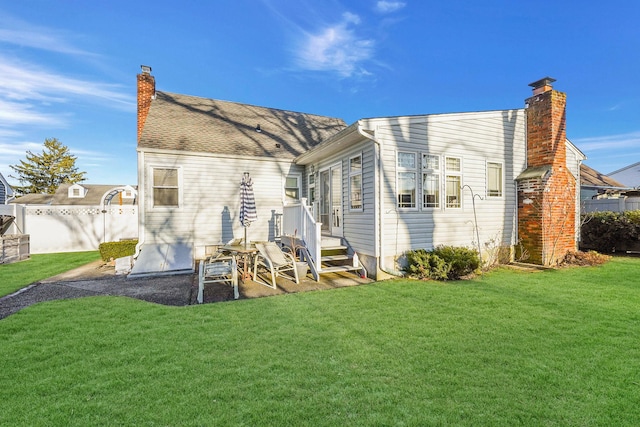 back of house with a lawn