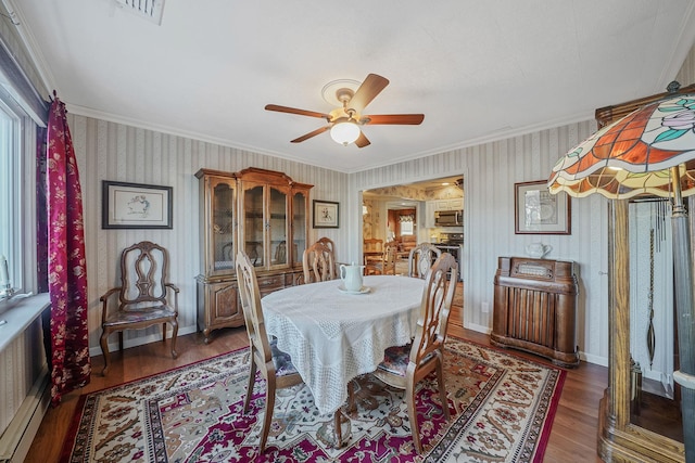 dining area featuring radiator, ceiling fan, ornamental molding, and hardwood / wood-style floors