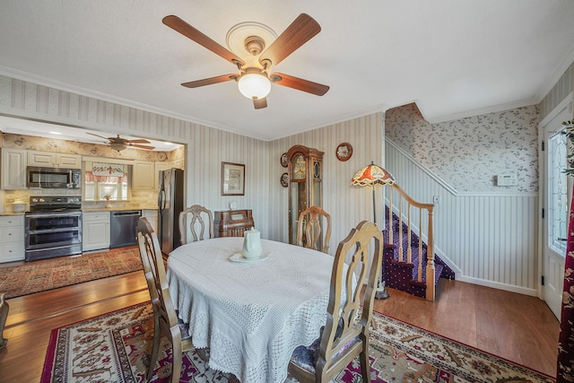 dining area with ceiling fan, hardwood / wood-style floors, and crown molding