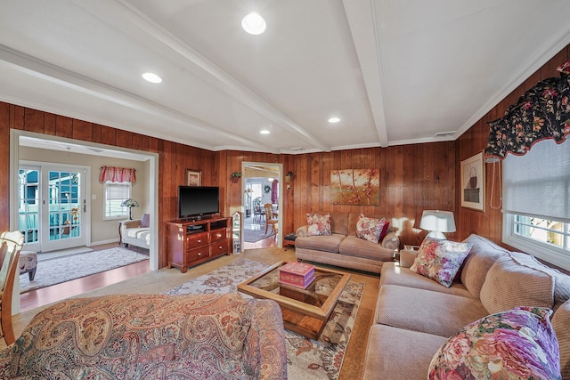 living room with wood walls and beamed ceiling