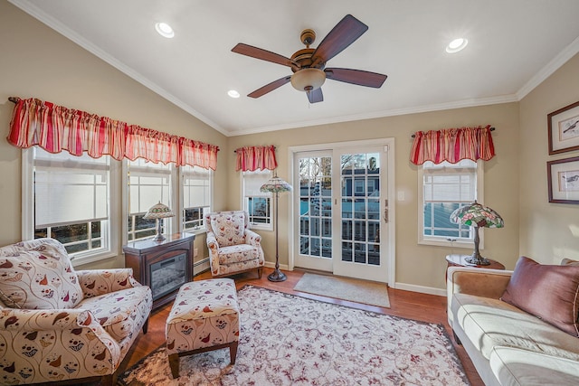 interior space featuring ceiling fan, hardwood / wood-style floors, ornamental molding, and vaulted ceiling