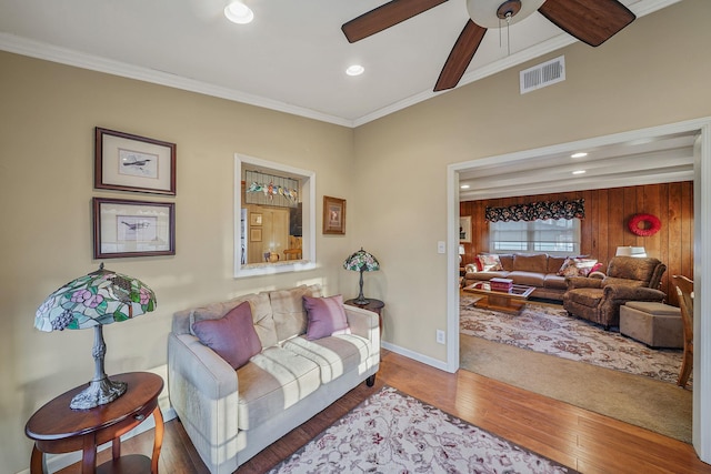 living room featuring ceiling fan, crown molding, and hardwood / wood-style flooring