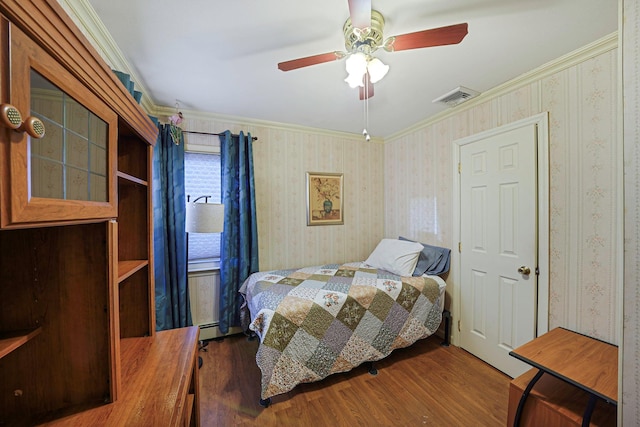 bedroom featuring ceiling fan, a baseboard radiator, hardwood / wood-style floors, and ornamental molding