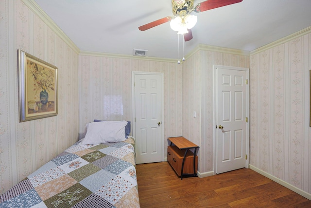 bedroom with ceiling fan, crown molding, and hardwood / wood-style floors