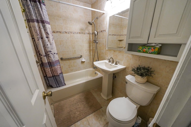 full bathroom featuring toilet, tile patterned flooring, tile walls, backsplash, and shower / tub combo