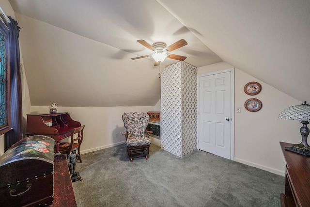 living area with ceiling fan, vaulted ceiling, and carpet flooring