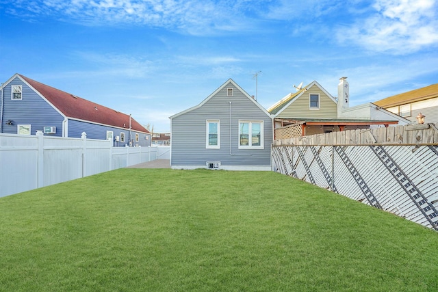 rear view of property featuring a lawn