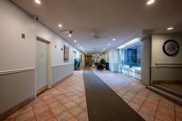 hall with light tile patterned floors