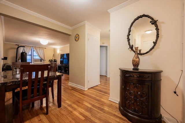 dining room featuring crown molding, cooling unit, and light hardwood / wood-style flooring