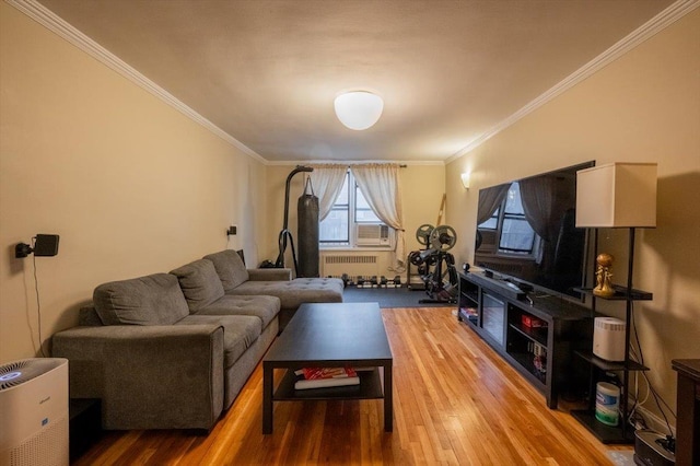 living room featuring hardwood / wood-style flooring, radiator heating unit, and ornamental molding