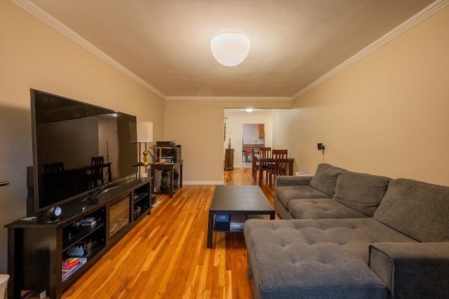 living room featuring wood-type flooring and ornamental molding