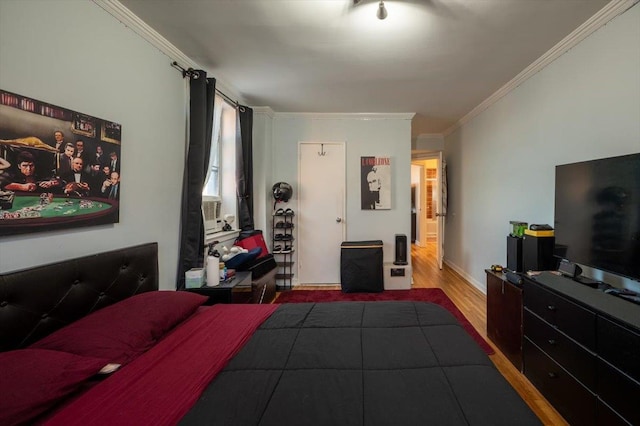 bedroom with hardwood / wood-style floors and crown molding