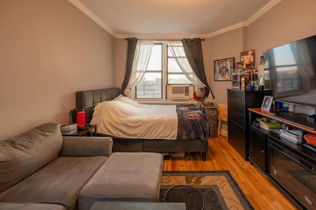 bedroom featuring light hardwood / wood-style flooring and ornamental molding