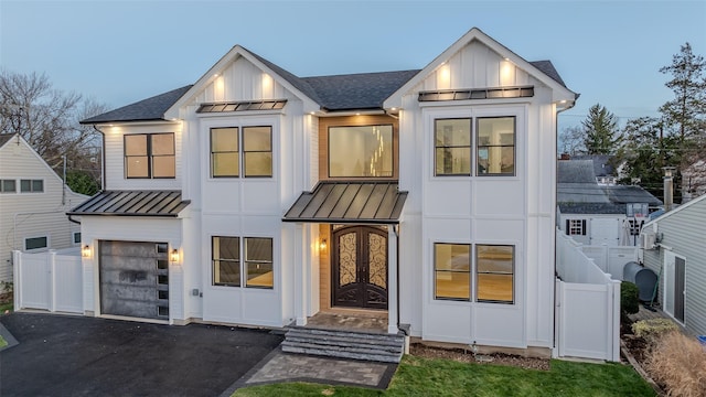 modern inspired farmhouse with a garage