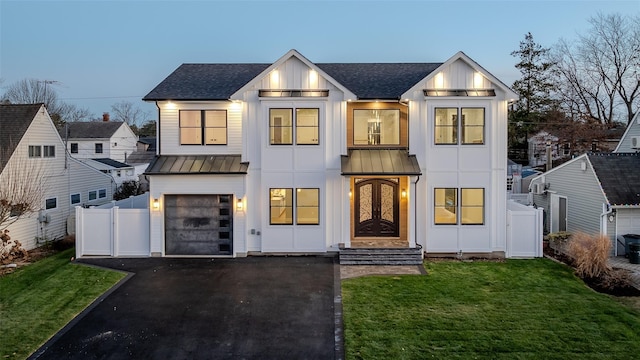 modern farmhouse with a garage and a yard