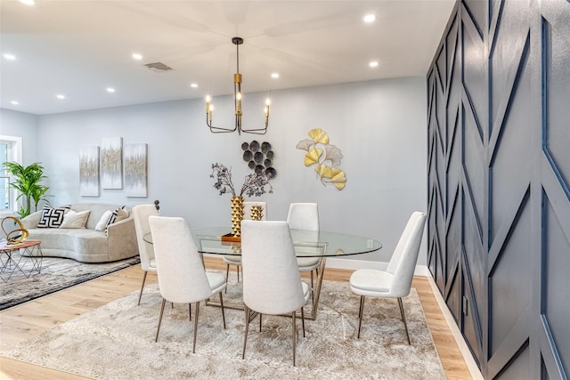 dining room featuring light hardwood / wood-style flooring and a notable chandelier