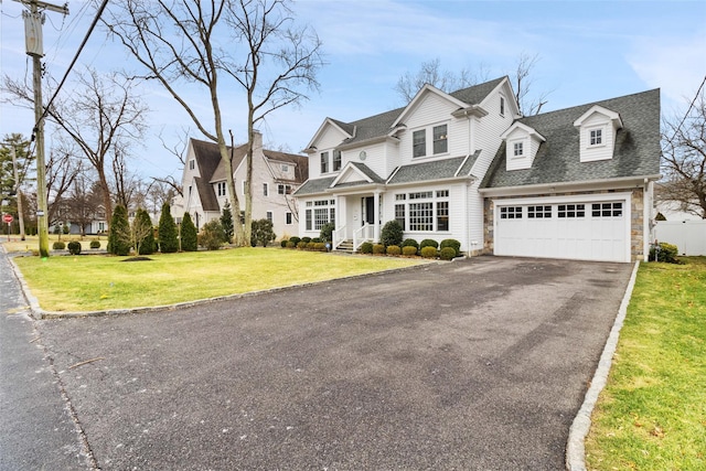 view of front facade featuring a garage and a front lawn