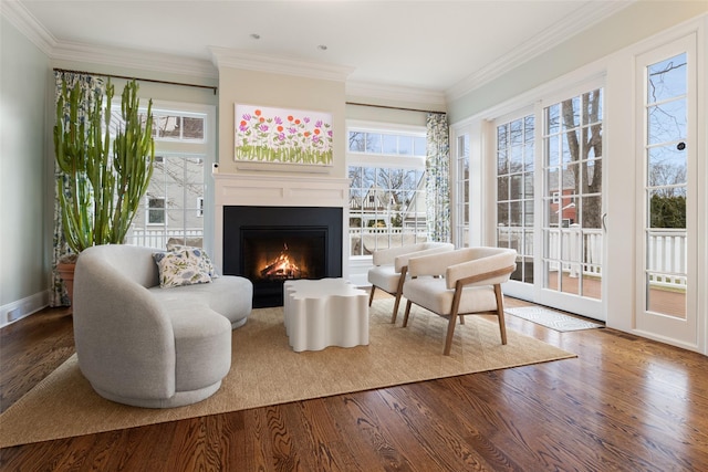 sitting room featuring ornamental molding and hardwood / wood-style floors