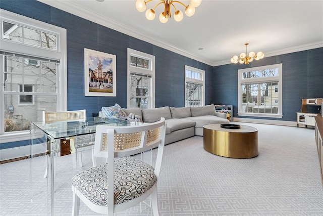 living room with ornamental molding, a notable chandelier, and carpet flooring